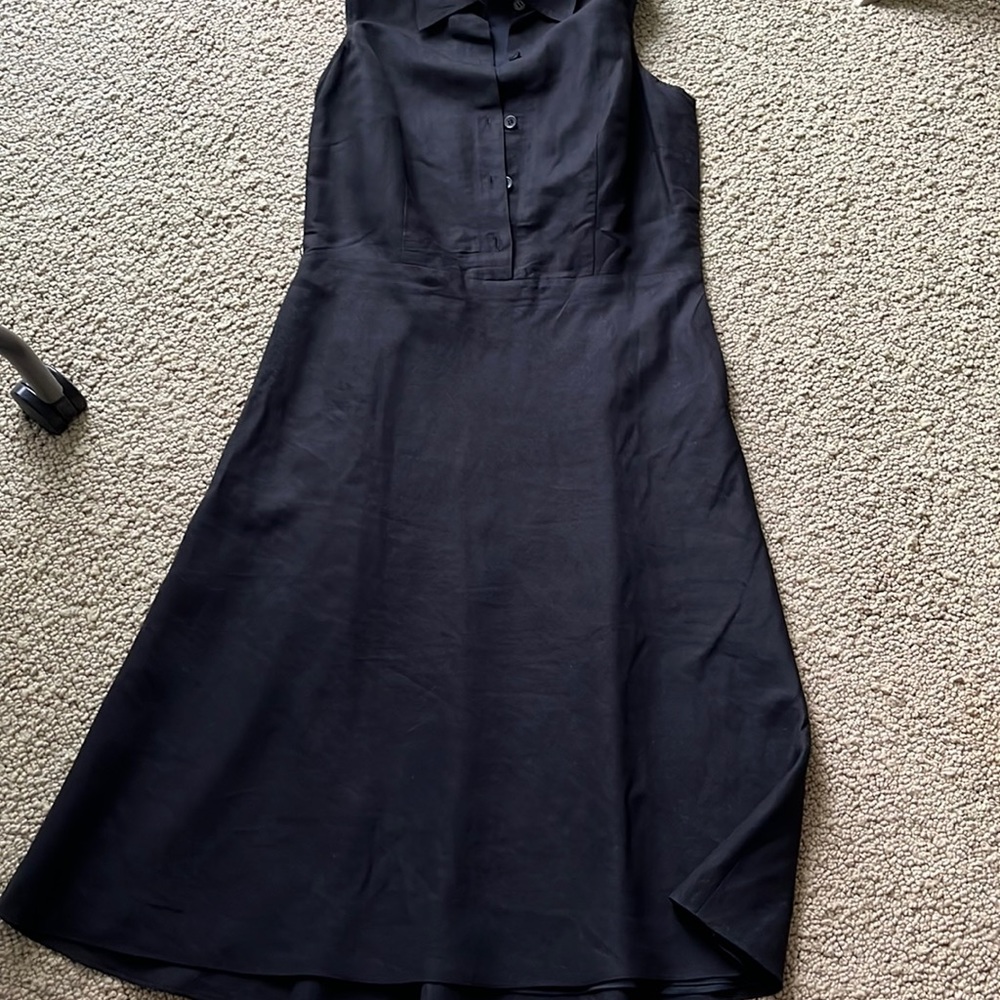 Sleeveless shirtwaist black linen dress. Just below knee